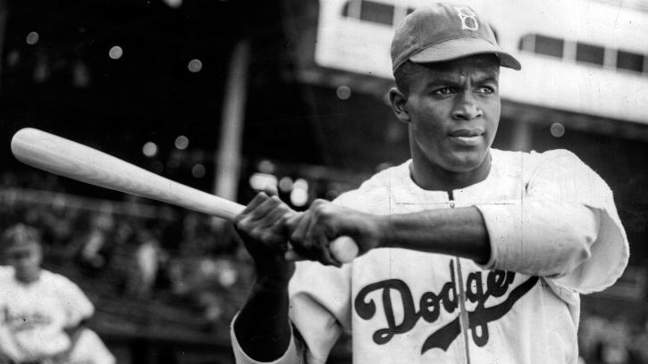 Which icon officially shattered the color barrier in 1947 as the first African American star in Major League Baseball?